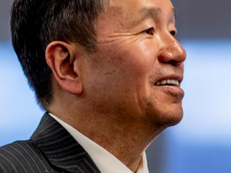 President Choi smiling as he speaks publicly.