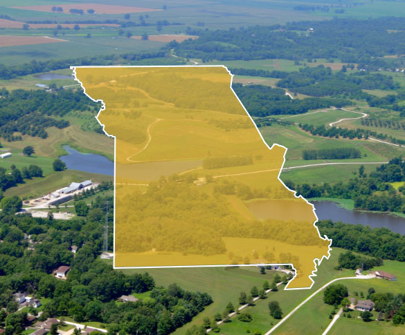 Missouri state outline over aerial photograph of Missouri fields and towns