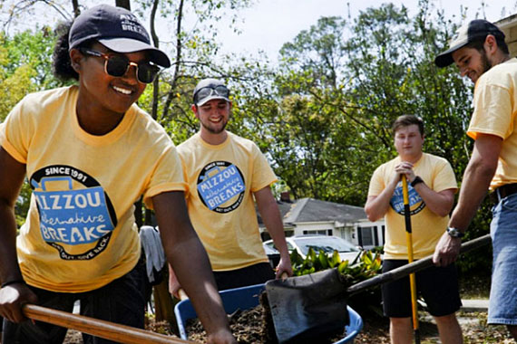 Mizzou Alternative Breaks students shoveling dirt